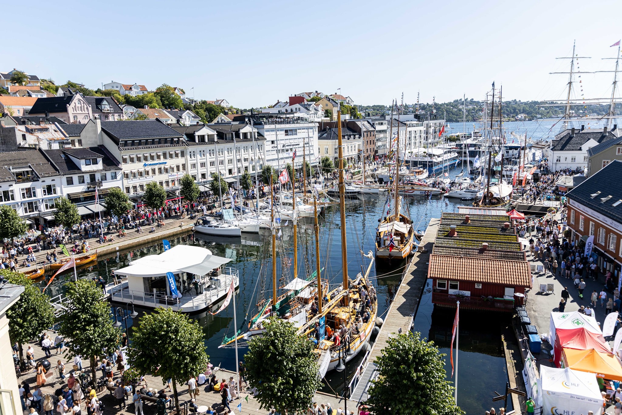 Bilde av havna i Arendal under Arendalsuka, med mange båter og masse folk.